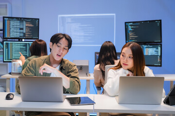 Professional computer engineer working on a new software technology design in the office Night,...