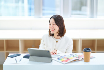 室内で仕事をするスーツ姿の女性