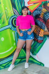 Latina Girl in Fashion Pose by Urban Graffiti Wall