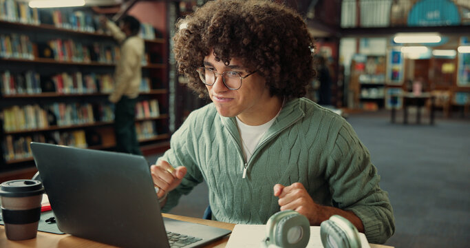 Student, excited and laptop with man in library for application approval, success and college. Scholarship award, university announcement and online results with person on campus for good news