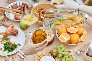 Sharing Refreshments and Fruits at Outdoor Gathering