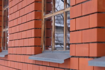 Close-up shot of a window on the side of a red brick house