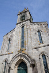 Fototapeta premium Neo-Gothic Church of Santiago in Mondoñedo, Lugo, Galicia, Spain. Historic architecture under clear skies in a quiet town square.