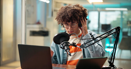 Man, presenter and headphones with mic for broadcast, recording podcast and sound check. Male...