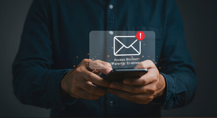 Close-up of hands holding a smartphone displaying a notification: 'Access Blocked, Parental Controls Enabled'.  A blocked email icon is shown with an alert. The image represents online parental contro