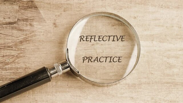 Animated text explains Reflective Practice. Words appear and fade away. The animation presents the Business concept on a light brown wooden surface