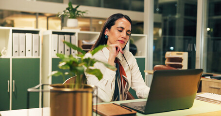 Thinking, laptop and business woman at night for online article, research and copywriting. Office,...