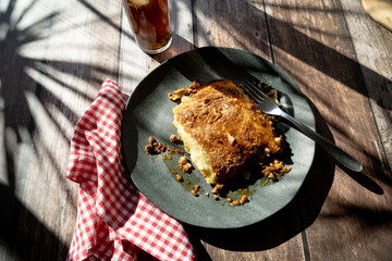 A slice of homemade meat pie served on a plate on a rustic table