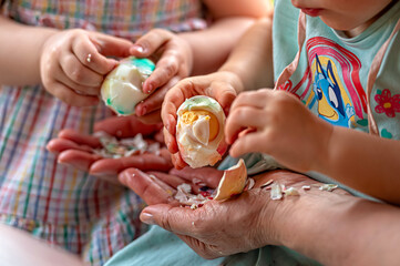 Children engaged in colorful egg decoration activity during springtime celebration