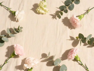 Minimalist Pastel Floral Flat Lay on Beige Linen Background