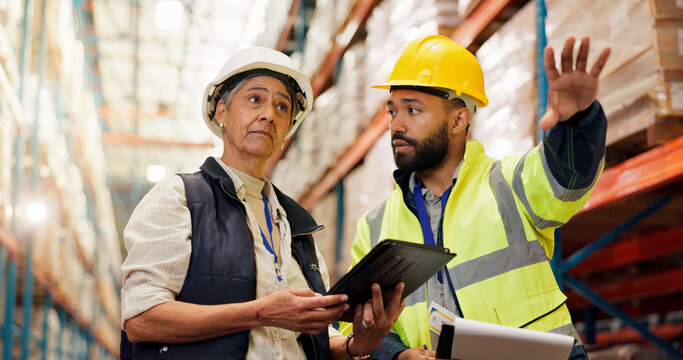 Logistics, team and planning with clipboard in warehouse for stock export, cargo or distribution. Low angle, tablet and people pointing to inventory for freight management, quality control or storage - Powered by Adobe