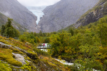 Young women in Briksdal glacier valley in south Norway, Europe