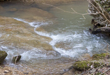 streambed, with muddy water in the spring period of the year during snowmelt