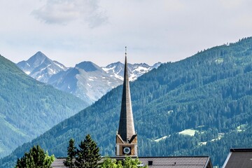 Church tower of Bad Hofgastein in front of the Austrian Alps