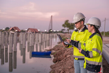 Civil Engineers Consult on Pile Driving in Water,Working at site of a large building project...