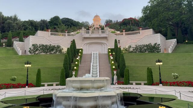 Haifa, Israel, June 10, 2025, Bahá'í Gardens at sunset. View from the lower terrace toward the fountain and the Shrine of the Báb. Landscape design.