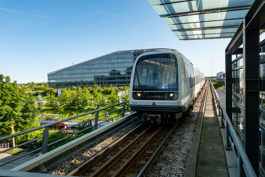 Copenhagen, Denmark  An elevated Metro train on the M1 line passes the modern buildings in the Orestad district.