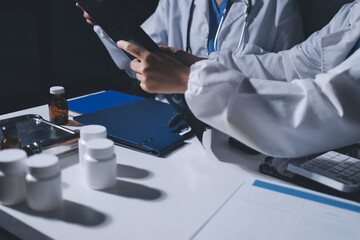Male and female doctors are having a meeting in a hospital room.