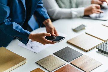 Consultant examining wood laminate textures in office design project