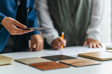 Consultant selecting laminate wood tones for decoration