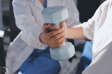 Unrecognizable uses blue hand weight during physical therapy session
