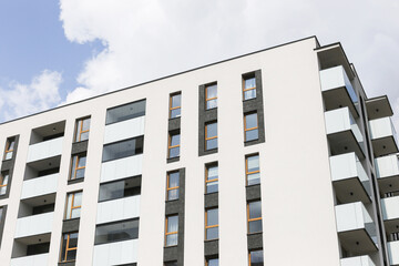 Modern apartment building. White facade with balconies. Contemporary residential housing. Urban city architecture. Clean minimal style.