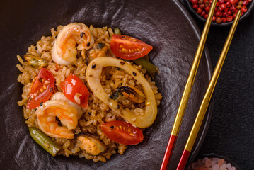 Rice and prawns or paella, a meal with seafood and vegetables. Cooked rice with shrimp