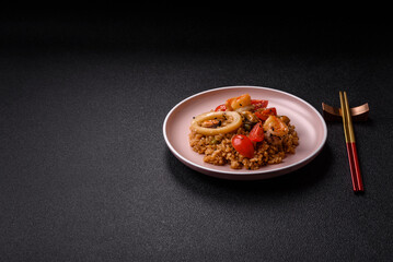 Rice and prawns or paella, a meal with seafood and vegetables. Cooked rice with shrimp