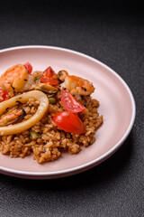 Rice and prawns or paella, a meal with seafood and vegetables. Cooked rice with shrimp