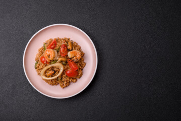 Rice and prawns or paella, a meal with seafood and vegetables. Cooked rice with shrimp