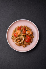 Rice and prawns or paella, a meal with seafood and vegetables. Cooked rice with shrimp