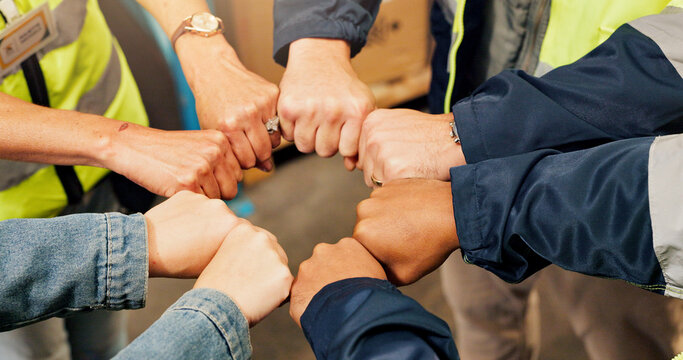 Construction, team and hands of people with fist bump for solidarity, collaboration and connection. Engineering, building warehouse and workers together for infrastructure, cooperation and support