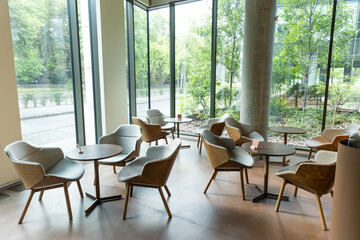 Interior of a nice modern cafe with cozy chairs and round tables