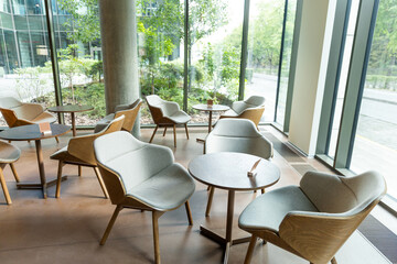 Interior of a nice modern cafe with cozy chairs and round tables