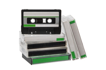 Stack of vintage audio cassette tapes in clear plastic cases with green labels on a transparent back