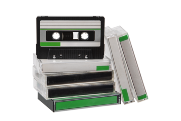 Stack of vintage audio cassette tapes in clear plastic cases with green labels on a transparent back