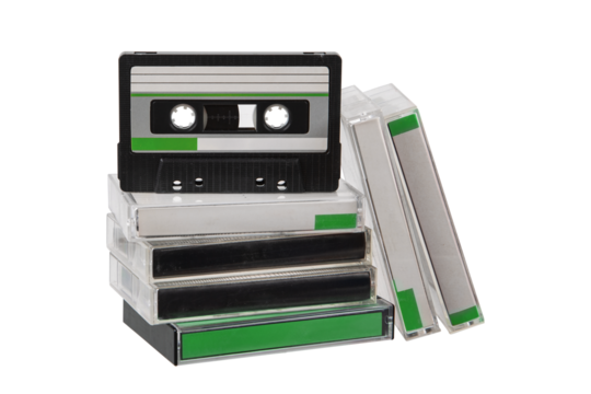 Stack of vintage audio cassette tapes in clear plastic cases with green labels on a transparent back