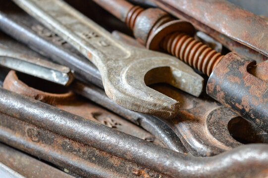 Close-up old rusty hand tools in metal toolbox. Emphasizes textures and patina on vintage wrenches hardwar industrial design Backgrounds mechanical restoration refurbishing garage workshops repair