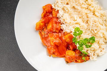Chicken curry rice butter chicken tikka masala spicy meat bowl on the table fresh tasty gourmet food background on rustic food top view copy space