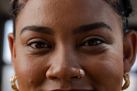 Confident woman smiling, showcasing empowerment in tech industry, at home