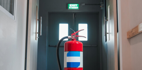 Fire extinguishers on floor available in fire emergency.