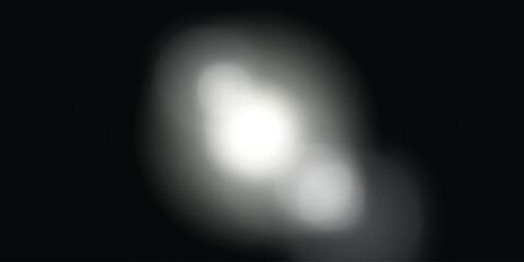 a bright, blurry, scattered light formation on a dark background that resembles a nebula or stellar object.