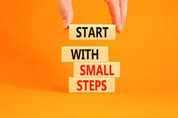 Start with small steps symbol. Concept words phrase Start with small steps on beautiful wooden...
