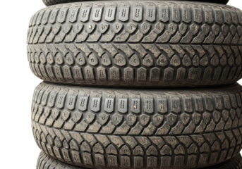 Three worn tires stacked high, isolated on transparent background