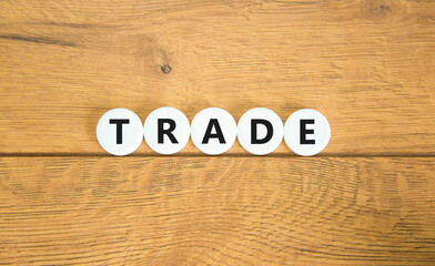 Trade symbol. Concept word Trade on beautiful white pills circles. Beautiful wooden table wooden background. Business lifestyle trade concept. Copy space.