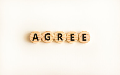 Agree symbol. Concept word Agree on beautiful wooden circles. Beautiful white table white...