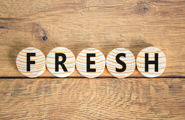 Fototapeta premium Fresh symbol. Concept word Fresh on beautiful wooden circles. Beautiful wooden table wooden background. Business lifestyle fresh concept. Copy space.