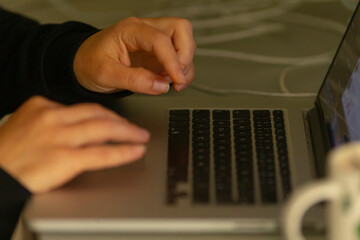A closeup view of hands skillfully typing on a laptop keyboard captures the essence of focus and...