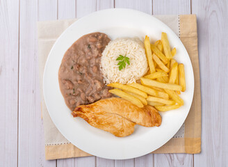 Chicken breast, rice, beans and french fries. Typical brazilian executive dish