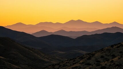 Fototapeta premium Serene Sunset Over Rolling Mountain Ranges and Valley Silhouette